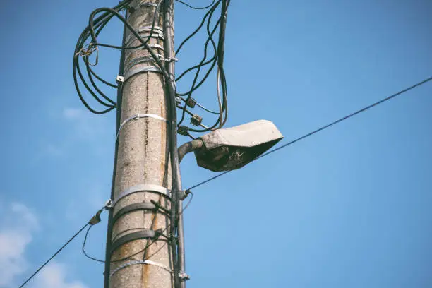 Photo of Low Angle View Of Broken Street Light Against Blue Sky