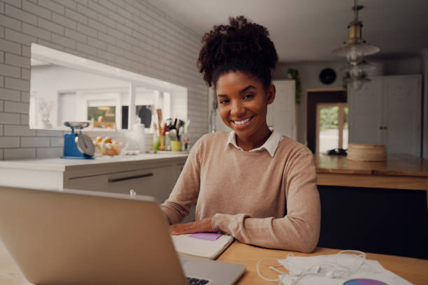 istock Student studying and learning online with a laptop in a desk at home during coronavirus pandemic while writing notes and looking at camera 1275839520