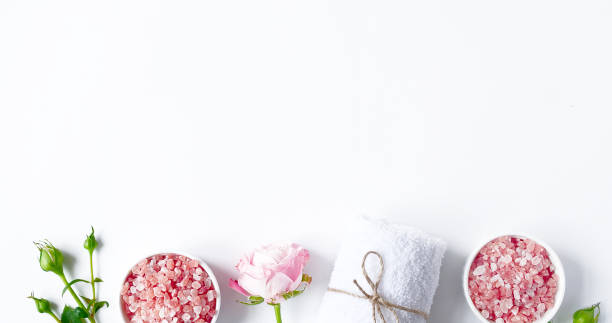 istock Spa flatlay composition. Sea salt in jar, towel, flower on white background. Top view, copyspace, banner. Daily care concept, relax and rest, bath procedure 1275839755