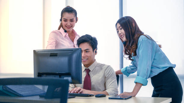 istock Group of young teamwork  businesspeople with headset and computer at office. 1275839929