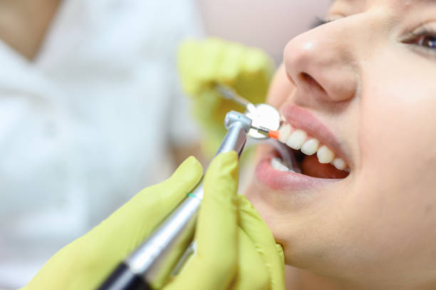 istock Woman having teeth examining at dentist 1275840820