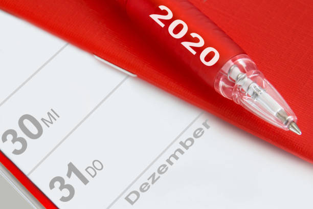 Red pen and German calendar December 2020 Red pen and German calendar December 2020 december 31 stock pictures, royalty-free photos & images
