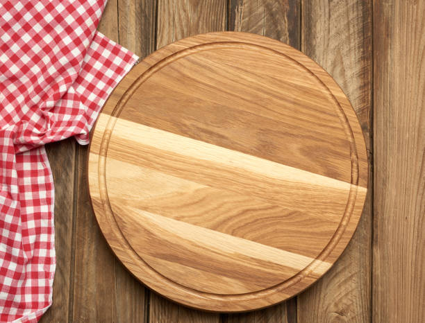istock new empty round wooden cutting board on gray table 1275841436