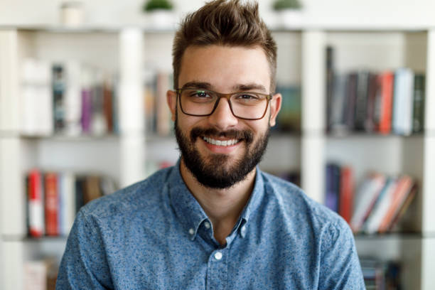 istock Smiling young man having online conference from home 1275841521