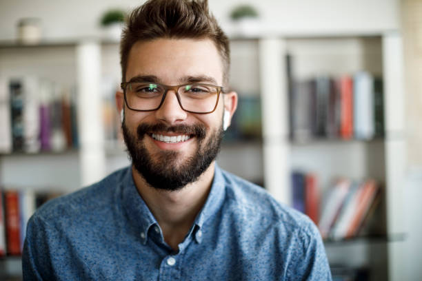 istock Smiling young man having online conference from home 1275841749