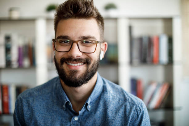 istock Smiling young man having online conference from home 1275842508
