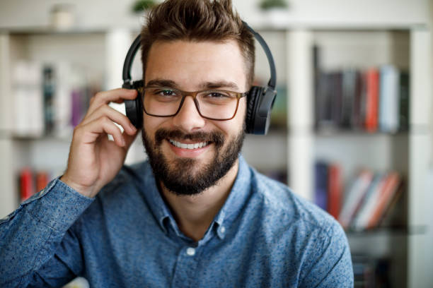 istock Smiling young man having online conference from home 1275842554