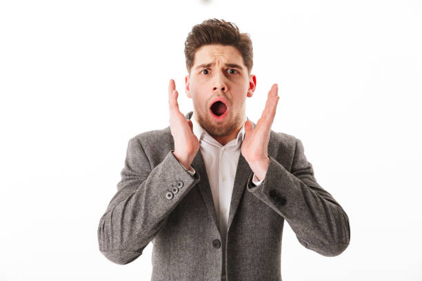 istock Shocked business man in jacket looking at the camera 1275843012