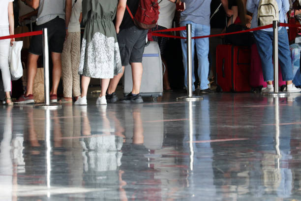istock Queue of people in the airport terminal, selective focus 1275844620