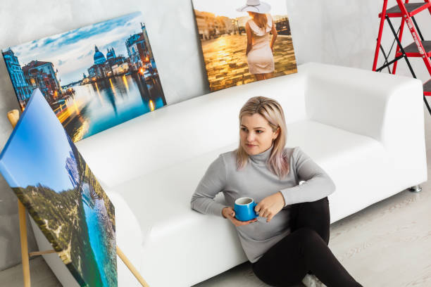 istock woman in studio with photo canvas 1275844670