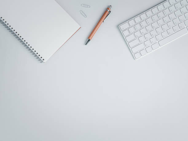 istock Top view of work space with brown pen and keyboard 1275844679