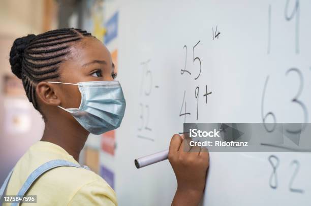 Elementary Girl Wearing Protective Face Mask At School Stock Photo - Download Image Now