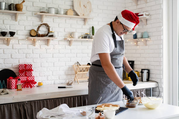 istock Handsome male chef wearing Santa hat making tiramisu cake. 1275848624