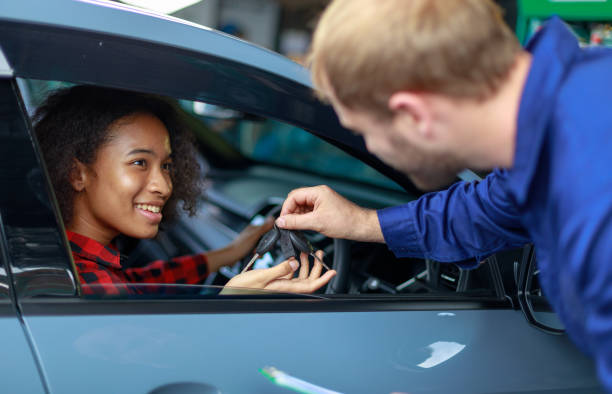 istock A female customer get car key from mechanic engineer. 1275848808