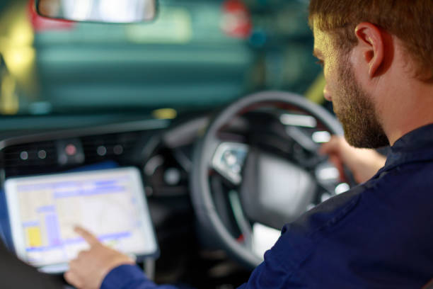 istock A Russian Male mechanic  with tablet pc computer making system diagnostic in car at workshop. car service, repair, technology, maintenance and people concept 1275848809