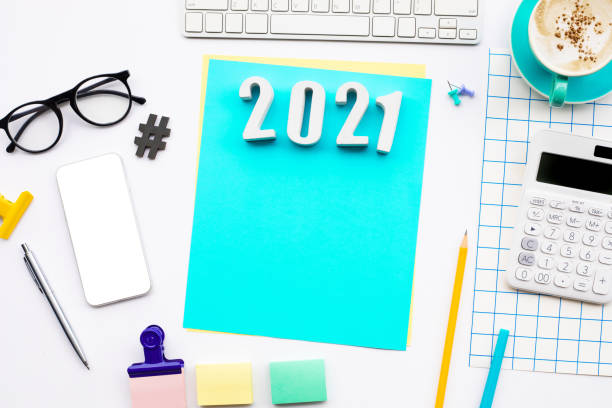 istock 2021 text with modern accessories of worker on table background 1275849779
