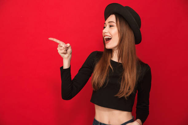 istock Cute young woman pointing. 1275849917