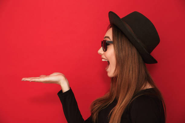 istock Side view image of cute young lady showing copyspace. 1275850030