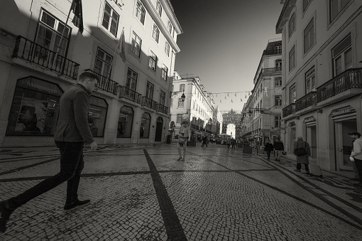 Lisbon, Portugal - December 5, 2019: A street artist performs as a native american in the Rua Augusta street in Lisbon downtown.