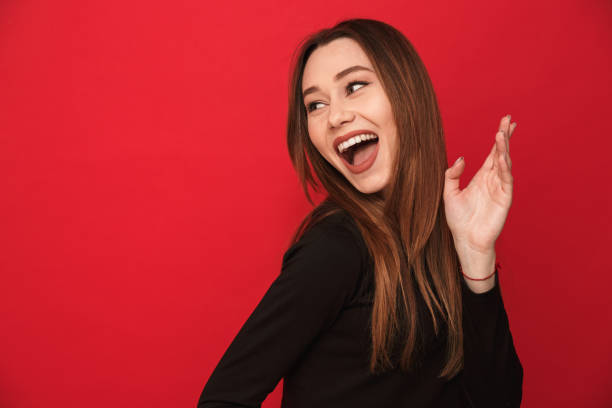 istock Woman standing isolated over red background 1275851020