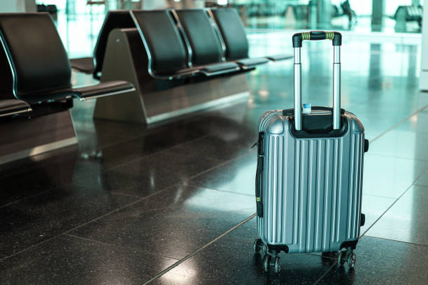 istock Suitcase in an empty airport departure lounge 1275851039