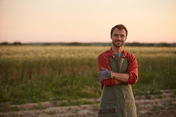 istock Smiling Young Farmer in Field 1275852384