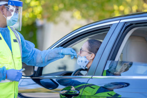 istock Medical professional taking a nasal swab, drive through testing centre 1275852650