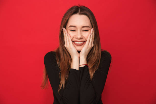 istock Cheerful young woman standing isolated 1275852905