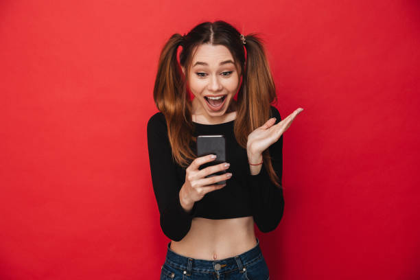 istock Cute excited screaming lady chatting by mobile phone. 1275852954