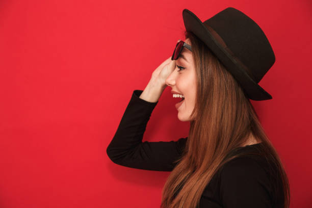 istock Cheerful young woman standing isolated 1275852973