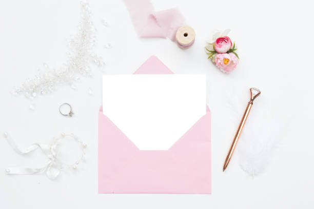 istock White blank paper in pink envelope. bridal themed accessories 1275853796