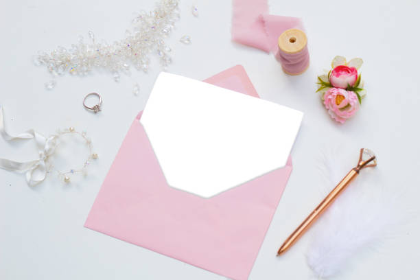 istock White blank paper in pink envelope. bridal themed accessories 1275853804
