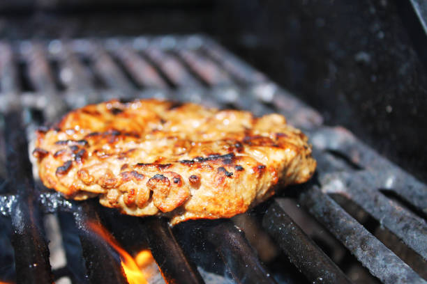 istock Hamburger Patty on a barbecue grill 1275854469