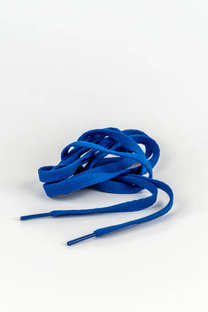 istock Blue shoe laces in a skein on a white background. Close-up. 1275855227