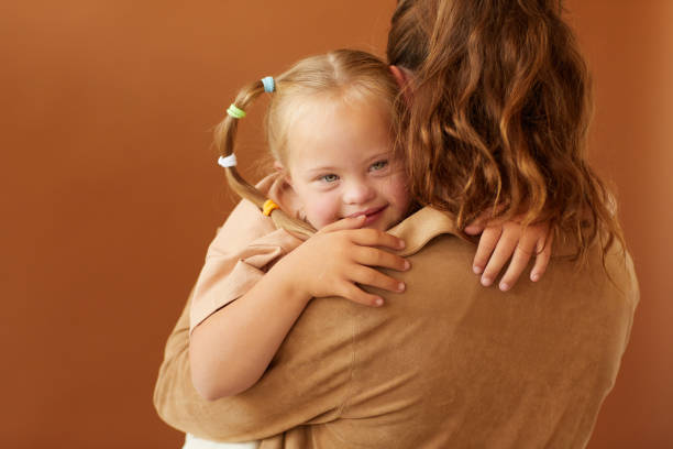 istock Mother Holding Daughter with Down Syndrome in Studio 1275856590