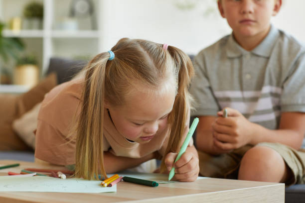 istock Cute Girl with Down Syndrome Enjoying Drawing 1275856667
