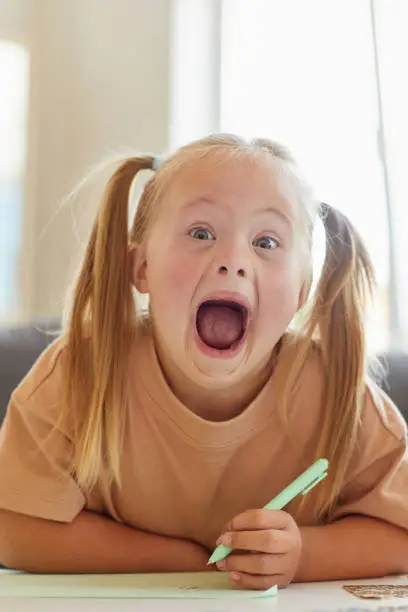 Photo of Girl with Down Syndrome Goofing at School