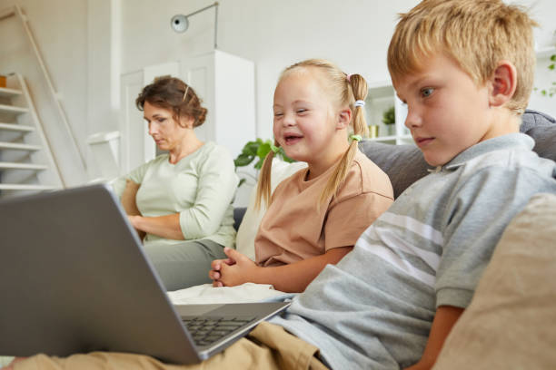 istock Girl with Down Syndrome Watching Cartoons 1275856769