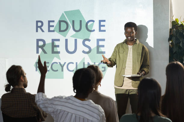 Young African Man Presenting at Ecology Conference Portrait of young African-American man giving speech on recycling and waste management during conference, copy space e waste photos stock pictures, royalty-free photos & images