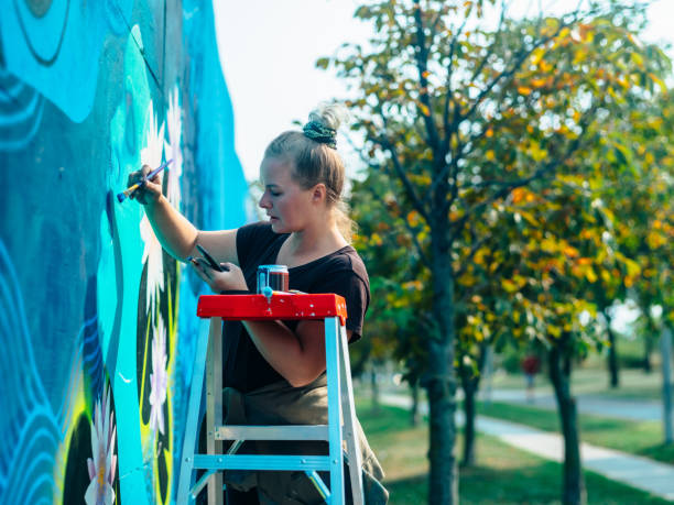 istock Female mural artist at work 1275858916