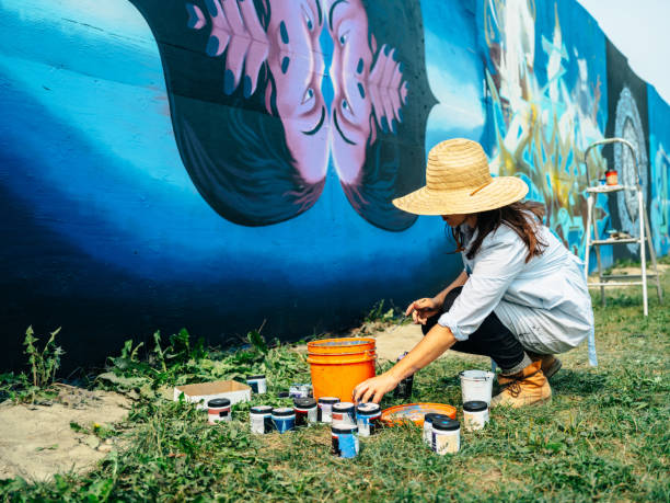 istock Female mural artist at work 1275859840