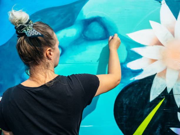 istock Female mural artist at work 1275859844