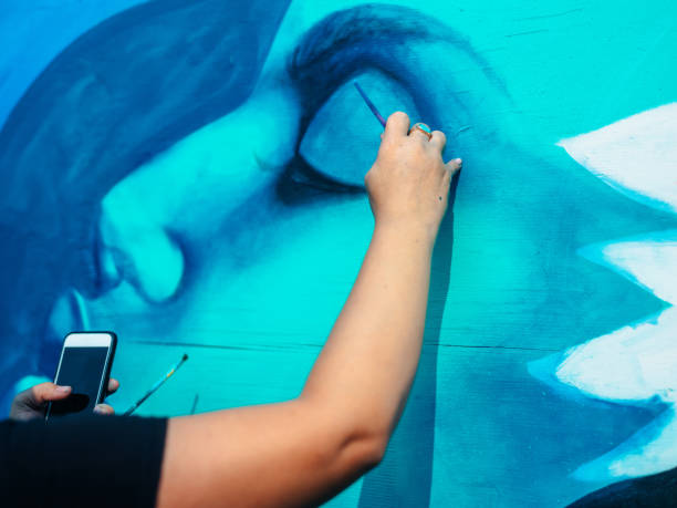 Hand of Female mural artist at work