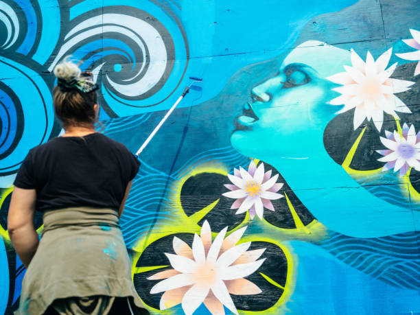 Female mural artist at work