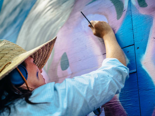istock Female mural artist at work 1275859959