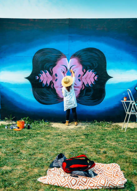 istock Female mural artist at work 1275860034