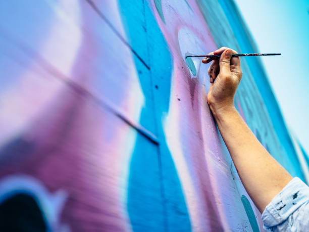 Hand of Female mural artist at work