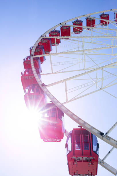 istock Ferris Wheel cabin over a blue sky 1275860183