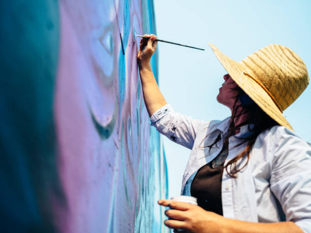 istock Female mural artist at work 1275860253