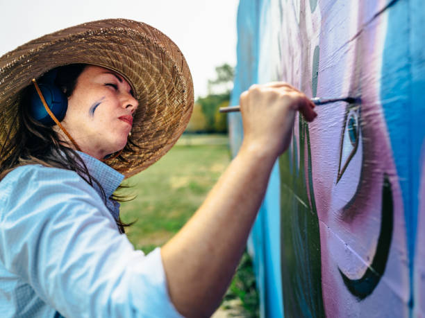 istock Female mural artist at work 1275860693